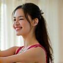 Happy client Choi Yu-na in a graceful yoga pose, smiling brightly.